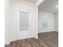 Bright entryway showcasing a white door with blinds and hardwood floors at 244 Oliver Dr, Locust Grove, GA 30248