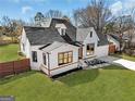 Beautiful home featuring a well-maintained yard, gray roof, and a mix of white brick and horizontal plank siding at 1774 Vesta Ave, Atlanta, GA 30337