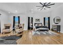 Bright main bedroom with high ceilings, hardwood floors, wingback chairs, and large windows at 1774 Vesta Ave, Atlanta, GA 30337