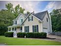 Beautiful two-story house with an attached garage, complemented by lush greenery and a well-maintained lawn at 60 Grange Ct, Sharpsburg, GA 30277
