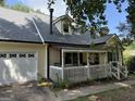 This home features a two-car garage and a cozy porch at 195 Wellington Dr, Mcdonough, GA 30252