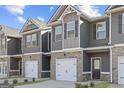 Newly constructed townhomes feature brick and siding exteriors with individual garages and modern architectural details at 120 Meadowview Dr # 10, Temple, GA 30179