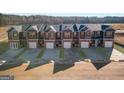 The streetscape displays the townhomes with their individual garages and driveways, creating a cohesive residential setting at 120 Meadowview Dr # 10, Temple, GA 30179