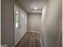 Welcoming foyer with hardwood floors, fresh paint, and natural light shining through a multi-paned sidelight at 421 Safari Cir, Stone Mountain, GA 30083