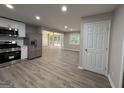 Open-concept kitchen boasts stainless steel appliances, new cabinets and flows seamlessly into the living room at 421 Safari Cir, Stone Mountain, GA 30083