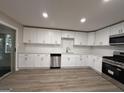 Modern kitchen featuring stainless steel appliances, white cabinetry, granite countertops, and a subway tile backsplash at 421 Safari Cir, Stone Mountain, GA 30083