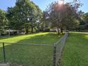 A spacious fenced backyard with lush greenery and mature trees, offering privacy at 85 North Ave, Hampton, GA 30228