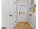 Welcoming entryway featuring wood flooring, a coat rack, and a door with window panel allowing ample natural light at 121 Meadowview Dr # 16, Temple, GA 30179
