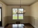 Cozy dining room featuring wood floors, crown molding, chandelier, and large window with street view at 987 Kora Sw Dr, Marietta, GA 30064