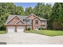 Charming two-story brick home with a well-manicured lawn and attached two car garage at 204 Eleanor Court, Stockbridge, GA 30281