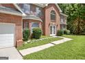 A beautifully maintained, two-story brick home with a well-manicured lawn at 204 Eleanor Court, Stockbridge, GA 30281