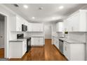 Modern kitchen with stainless steel appliances, white cabinets and subway tile backsplash at 1783 Cheyenne Trl, Jonesboro, GA 30236