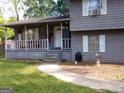 Home's covered front porch and doorway at 55 Porter Cir, Hampton, GA 30228