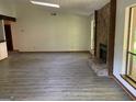 Bright living room featuring wood floors, a stone fireplace, and a skylight at 215 Lakeland Ct, Roswell, GA 30076