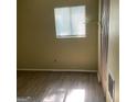 Bedroom with laminate flooring, neutral walls and a window offering natural light at 213 Whipporwill Way, Riverdale, GA 30274