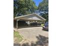 Large car port provides ample parking and storage with space for multiple vehicles at 921 Hightower Trl, Oxford, GA 30054