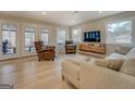 Bright living room with comfortable seating, TV, windows overlooking the trees and a sliding glass door to a deck at 480 Mitchell Rd, Covington, GA 30014