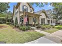 Lovely home with inviting front porch, mature landscaping and charming details, perfect for relaxing outdoors at 135 Adam Ridge Ln, Fayetteville, GA 30214