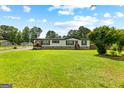 Front exterior view showcasing a well-maintained lawn and traditional home design at 80 David Rd, Hampton, GA 30228