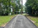 Long paved driveway leading to the house surrounded by lush trees at 3106 Jodeco Dr, Jonesboro, GA 30236