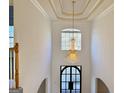 Entryway with soaring ceilings and a decorative chandelier and front door at 6765 Crofton Dr, Alpharetta, GA 30005