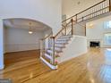 Spacious foyer featuring hardwood floors and an elegant staircase at 6765 Crofton Dr, Alpharetta, GA 30005