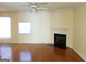 Spacious living room with hardwood floors, a cozy fireplace, and ample natural light at 2116 Charter Ln, Lithonia, GA 30058