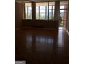Inviting living room with large windows offering natural light and beautiful parquet floors throughout at 3060 Nw Pharr Ct # 517, Atlanta, GA 30305