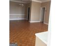 Bright and airy living room showcasing beautiful parquet floors, neutral walls, and classic moldings at 3060 Nw Pharr Ct # 517, Atlanta, GA 30305