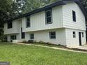 An exterior shot of the home shows the painted brick foundation and fresh landscaping at 1608 Bogota Way, Jonesboro, GA 30236