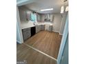 A freshly remodeled kitchen features light gray cabinets, new appliances, and new flooring at 1608 Bogota Way, Jonesboro, GA 30236