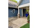 Carport attached to the house with a concrete driveway and partial view of the backyard at 75 Orchard Dr, Covington, GA 30014