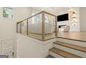 Stylish living room area with hardwood flooring, glass railing, and a comfortable seating arrangement at 1337 Grey Fox Ct # 7, Atlanta, GA 30306