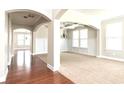 Bright and spacious foyer with hardwood floors and archways at 5550 Rialto Way, Cumming, GA 30040