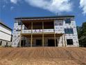 Under construction home featuring a spacious deck, expansive windows, and walkout basement at 2257 Buford Dam Rd, Buford, GA 30518