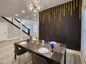 Dining area featuring contemporary decor, stylish lighting, and a unique accent wall for a modern touch at 1089 White Oak Sw Ave, Atlanta, GA 30310