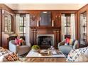 Inviting living room with a fireplace, wood paneled walls, and comfortable seating at 1585 S Ponce De Leon Ave # M4, Atlanta, GA 30307