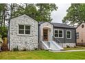 Updated home exterior, featuring stone and gray siding at 1699 Olympian Sw Way, Atlanta, GA 30310