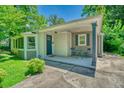 Inviting exterior with a covered porch, cute seating area, and well-maintained landscaping at 3182 Lake Ave, Atlanta, GA 30354
