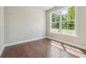 Bright bedroom features hardwood floors and large window offering ample natural light at 376 Lakeside Ct, Canton, GA 30114