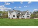 Charming two-story home featuring expansive green lawn and board and batten accents at 170 Ewing Way, Dacula, GA 30019