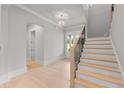 Bright foyer featuring hardwood floors, staircase, and natural light at 170 Ewing Way, Dacula, GA 30019