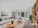 Bright living room features large windows, neutral tones, and stylish staging for an inviting space at 165 Zelkova Dr, Fayetteville, GA 30215