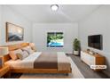 Relaxing bedroom offers serene views of the pool, with contemporary furnishings and natural light at 165 Zelkova Dr, Fayetteville, GA 30215