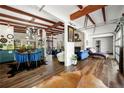 Open floor plan with exposed beams, hardwood floors, comfortable seating, and modern lighting fixtures at 3679 Herschel Rd, College Park, GA 30337