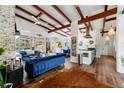 Bright living room features vaulted ceilings, exposed beams, hardwood floors, and garage door windows at 3679 Herschel Rd, College Park, GA 30337