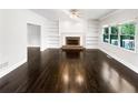 Living room features a fireplace, built-in bookshelves and hardwood floors at 819 Bermuda Run, Woodstock, GA 30189