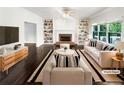 Bright living room features a fireplace, built-in bookshelves, and large windows at 819 Bermuda Run, Woodstock, GA 30189