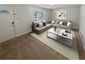 Living room with a neutral color palette, large sectional sofa, and an abundance of natural light at 125 Enterprise Dr, Temple, GA 30179