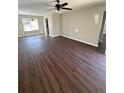 Spacious living room with new wood flooring and a modern ceiling fan at 111 Crowder St, Jonesboro, GA 30236